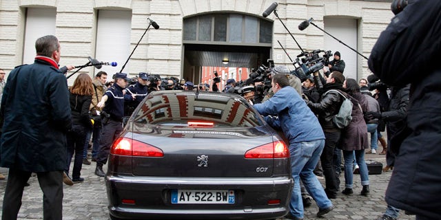 Feb. 21: The car of Dominique Strauss-Kahn enters the Gendarmerie surrounded by the media as he arrives for questioning.