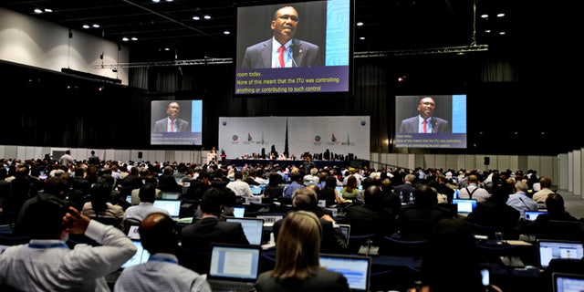 Participants listen to the speech of Hamdoun Toure, Secretary General of International Telecommunication Union, ITU, seen on screens, at the eleventh day of the World Conference on International Telecommunication in Dubai, United Arab Emirates, Monday Dec. 3, 2012.