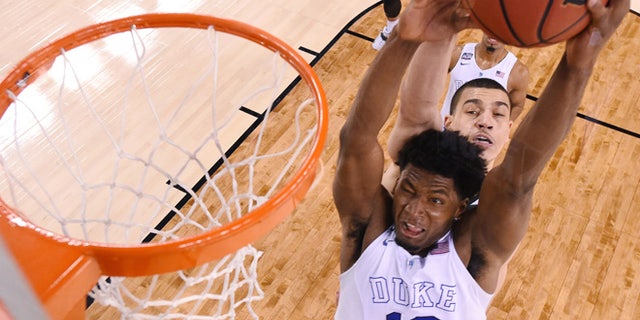 Apr. 4, 2015: Duke's Justise Winslow (12) is fouled by Michigan State's Gavin Schilling, rear, during the second half of the NCAA Final Four tournament college basketball semifinal game. (AP)