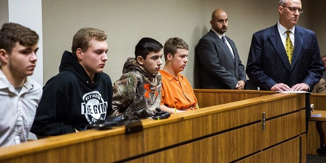 From left to right: Trevor Gray, 15, Alexzander Miller, 15, Mikadyn Payne, 16, and Kyle Anger, 17, appear for their arraignment.