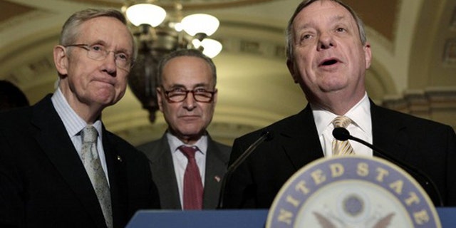 Sen. Dick Durbin, right, speaks to the media, alongside Senate Majority Leader Harry Reid, left, and Sen. Charles Schumer on Capitol Hill in Washington June 23.
