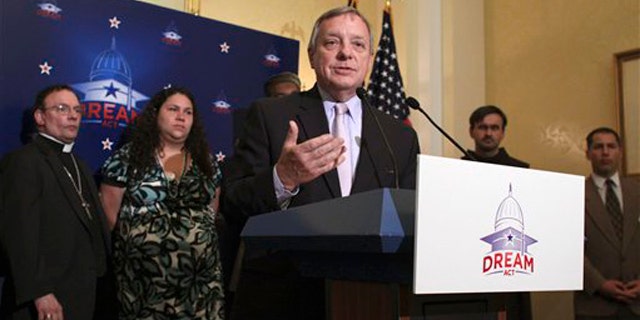 Sen. Dick Durbin, at podium, joined by religious leaders, gestures during a news conference on Capitol Hill July 12 to discuss the upcoming 'DREAM Act Sabbath.'