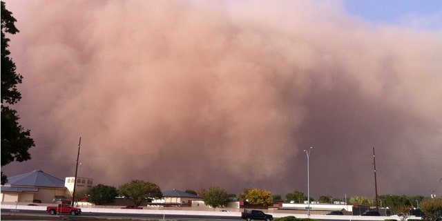 Oct. 17, 2011: This photo provided by John Holsenbeck shows a billowing wall of red dust approaching Lubbock, Texas.