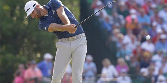 Dustin Johnson hits his tee shot on the 10th hole during the final round of the U.S. Open golf championship at Oakmont Country Club on Sunday, June 19, 2016, in Oakmont, Pa. (AP Photo/John Minchillo)