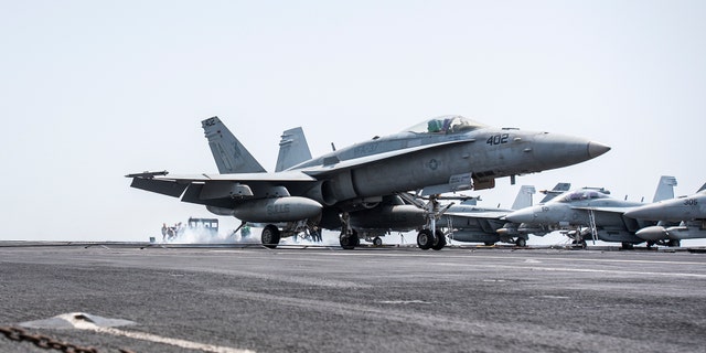 An F/A-18C Hornet landing on the flight deck of the aircraft carrier USS George H.W. Bush in April.