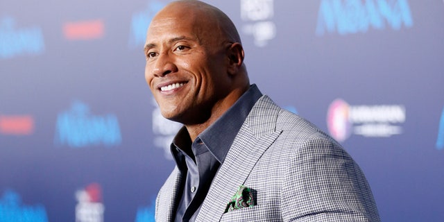 Dwayne 'The Rock' Johnson poses at the premiere of Walt Disney Animation Studios' "Moana" in Hollywood, California, on November 14, 2016.