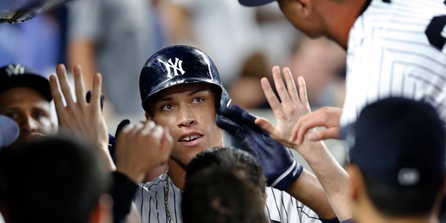 July 7: New York Yankees' Aaron Judge, center, is congratulated after his fifth-inning home run against the Milwaukee Brewers in a baseball game in in New York.