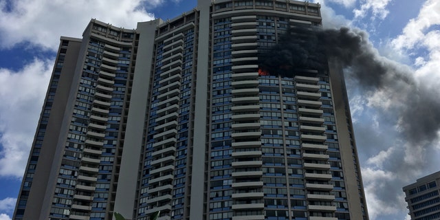 July 14: Smoke billows from a high-rise apartment building in Honolulu,