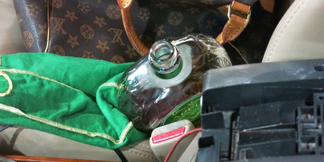 An open bottle of Crown Royal Liquor was found in the passenger seat of Schleicher's car.