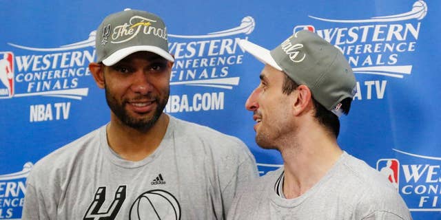 San Antonio Spurs' Tim Duncan, left and Manu Ginobili talk following Game 6 of the Western Conference finals NBA basketball playoff series against the Oklahoma City Thunder in Oklahoma City, Saturday, May 31, 2014. San Antonio won 112-107, and advanced to the NBA Finals. (AP Photo/Sue Ogrocki, Pool)