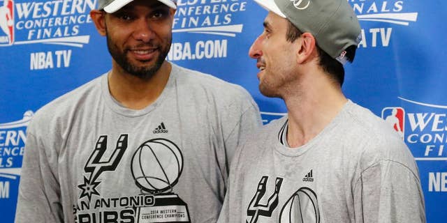 San Antonio Spurs' Tim Duncan, left and Manu Ginobili talk following Game 6 of the Western Conference finals NBA basketball playoff series against the Oklahoma City Thunder in Oklahoma City, Saturday, May 31, 2014. San Antonio won 112-107, and advanced to the NBA Finals. (AP Photo/Sue Ogrocki, Pool)