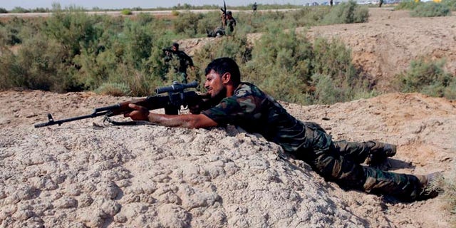 FILE: August 23, 2014: A Shite fighter, who has joined in the fight against Islamic State, taking part in field training in Najaf, Iraq.