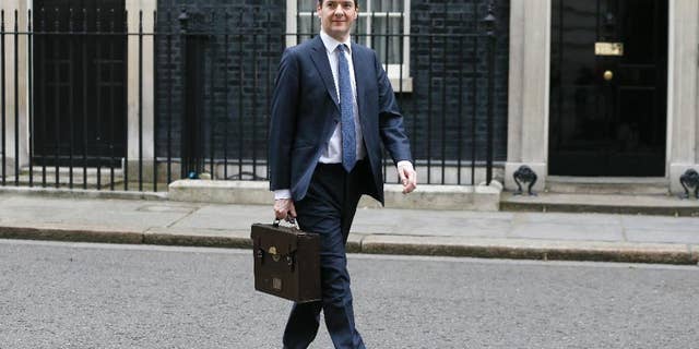 Britain's Chancellor George Osborne walks across Downing Street on his way to attend a press conference at the Foreign Office with Christine Lagarde of the International Monetary Fund, in London, Friday, May 13, 2016. The International Monetary Fund has warned that London’s status as a global financial center would be jeopardized should Britain vote to leave the European Union in a June 23 referendum. The global body that promotes financial stability says in a report Friday that the city’s powerful financial services sector would lose clout because of the loss of so-called “passporting’’ rights. These rights allow professionals to work in any EU country, without seeking licenses. (AP Photo/Kirsty Wigglesworth)