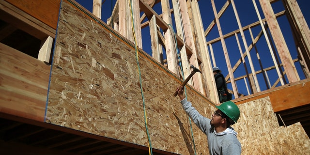 PETALUMA, CA - JANUARY 21: A worker hammers nails as he builds a new home on January 21, 2015 in Petaluma, California. According to a Commerce Department report, construction of new homes increased 4.4 percent in December, pushing building of new homes to the highest level in nine years. (Photo by Justin Sullivan/Getty Images)