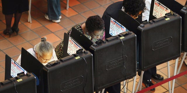People cast their votes at a polling station at the Miami-Dade Government Center in Florida.