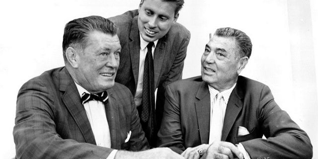 Boxing legends Gene Tunney, left, and Jack Dempsey, right, pose with Tunney's son, John V. Tunney, at a news conference in Los Angeles. Sept. 23, 1964.