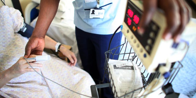 BIRMINGHAM, ENGLAND - MARCH 16: A nurse tends to recovering patients on a general ward at The Queen Elizabeth Hospital on March 16, 2010 in Birmingham, England. As the UK gears up for one of the most hotly contested general elections in recent history it is expected that that the economy, immigration, industry, the NHS and education are likely to form the basis of many of the debates. (Photo by Christopher Furlong/Getty Images)