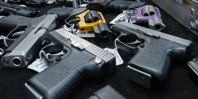 FILE - In this Saturday, Jan. 26, 2013 file photo, handguns are displayed on a vendor's table at an annual gun show in Albany, N.Y. In an Associated Press USA TODAY Network investigation into accidental shootings involving children from Jan. 1, 2014, to June 30, 2016, more than 320 minors and more than 30 adults were fatally shot. (AP Photo/Philip Kamrass)