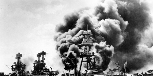 The USS West Virginia, Tennessee, and Arizona battleships are shown damaged and burning after the Japanese attack on Pearl Harbor, Hawaii, in 1941. "I wanted to help save our country," said veteran Stanley Tauber of New York about his entry into the service when he was a very young man. Tauber is now 102 years old.
