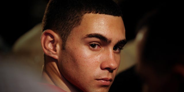 FILE - In this June 30, 2010 file photo, Elian Gonzalez attends an official event with Cuba's President Raul Castro in Havana, Cuba. The young Cuban raft boy who was the subject of a high-profile international custody dispute more than a decade ago, turned 20 on Friday, Dec. 6, 2013. Cuban state media report that Gonzalez is in Ecuador as part of a delegation of the World Festival of Youth and Students, his first trip overseas trip since he was reunited with his father in 2000. (AP Photo/Adalberto Roque, File Pool)
