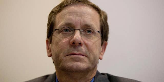 Zionist Union party co-leaders Isaac Herzog listens to Tzipi Livni as she delivers a statement in the party's election headquarters in Tel Aviv, Israel, Wednesday, March 18, 2015, a day after Israel held legislative election. Netanyahu's right-wing Likud Party scored a resounding victory in Israel's election, final results showed Wednesday, a stunning turnaround after a tight race that had put his lengthy rule in jeopardy. (AP Photo/Ariel Schalit)