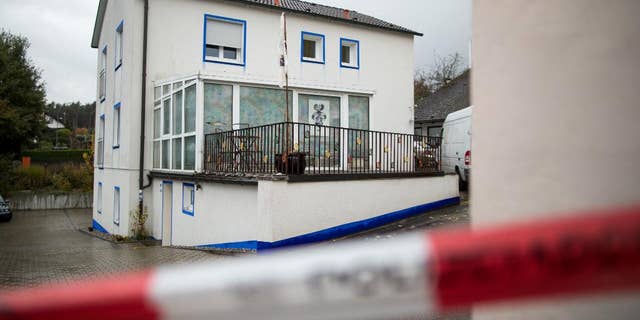 The house in which a 49-year-old anti-government extremist fired at four policemen during a raid on the Wednesday is pictured in Georgensgmuend, Germany, Thursday, Oct. 20, 2016. A 32-year-old police officer died early Thursday, a day after being shot by by the extremist who had hoarded dozens of weapons at his home, officials said. (Daniel Karmann/dpa via AP)
