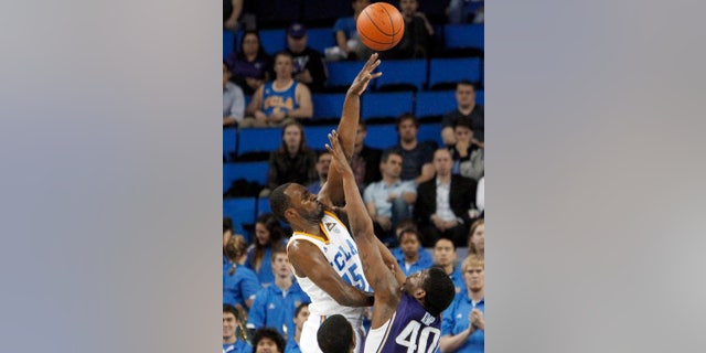 UCLA's Shabazz Muhammad (15) shoots over Washington forward Shawn Kemp Jr. (40) in the first half of an NCAA college basketball game in Los Angeles on Thursday, Feb. 7, 2013. (AP Photo/Reed Saxon)