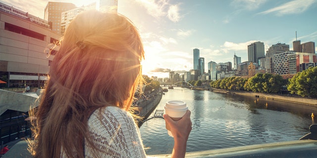 A woman enjoys the sunrise in Melbourne, Australia.