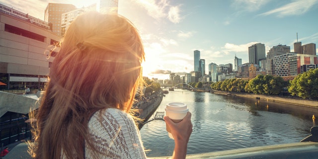 A woman enjoys the sunrise in Melbourne, Australia.