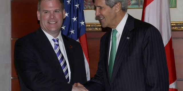U.S. State Secretary John Kerry, right, greets Canadian Foreign Minister John Baird prior to their bilateral meeting on the sideline of the Asia-Pacific Economic Cooperation (APEC) ministerial meeting in Nusa Dua, Bali, Indonesia, Saturday, Oct. 5, 2013. (AP Photo/Dita Alangkara)