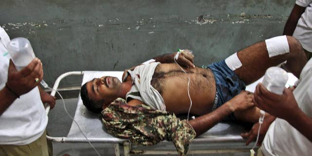 An Indian Border Security Force soldier is carried on a stretcher for treatment at the Government Medical College Hospital after being injured in attacks between India-Pakistan firing at the border area in Ranbir Singh Pura, in Jammu, India, Thursday, Oct. 9, 2014. Troops trading heavy fire between Pakistan and Indian-controlled Kashmir plunged civilians on both sides into grief with many killed and wounded this week, prompting many to question how two nations committed to a 2003 cease-fire could be targeting civilians while trading blame about who started shooting first. (AP Photo/Channi Anand)