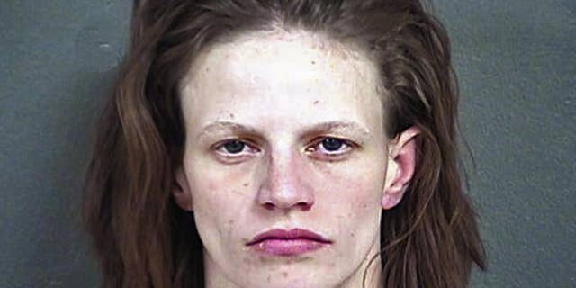 FILE - This undated file photo provided by the Wyandotte County Detention Center in Kansas shows Heather Jones, who was sentenced Monday, Nov. 14, 2016, to life in prison for her role in the death of her 7-year-old stepson, who authorities say had been brutally abused and whose remains were found in the family's home in Kansas City, Kan. (Wyandotte County Detention Center via AP, File)