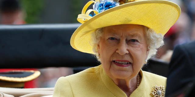 FILE - This is a Tuesday, June, 14, 2016 file photo of Britain's Queen Elizabeth II as she arrives by carriage on the first day of the Royal Ascot horse race meeting at Ascot, England. Buckingham Palace officials said Wednesday Dec. 21, 2016 that Queen Elizabeth II and her husband Prince Philip have delayed their planned Christmas trip because both are suffering from heavy colds. (AP Photo/Alastair Grant/file)