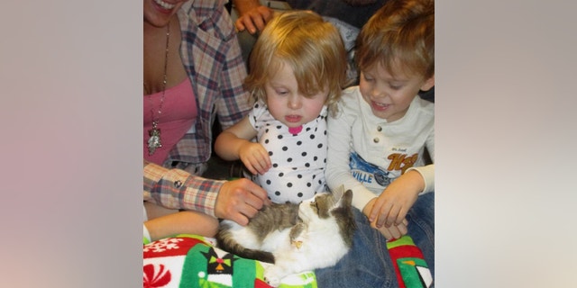 Scarlette Tipton plays with her new kitten.