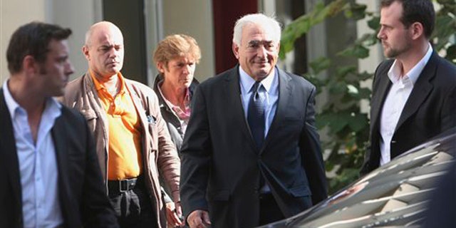 Former IMF chief Dominique Strauss-Kahn, 2nd right, leaves a police station after a one-on-one meeting with writer, Tristane Banon, who accuses him of attempted rape, in Paris, France, Thursday, Sept. 29, 2011.