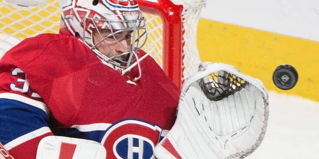 FILE - In this Oct. 20, 2015, file photo, Montreal Canadiens goaltender Carey Price makes a save against the St. Louis Blues during the third period of an NHL hockey game, in Montreal. The Montreal Canadiens say goaltender Carey Price and defenseman P.K. Subban will not play in the final two games of the season. The club revealed Price has been out with a sprained medial collateral ligament sprain in his right knee suffered Nov. 25 against the New York Rangers. Subban, Montreal’s top defenseman, has been out since suffering a neck injury March 10 against Buffalo.(Graham Hughes/The Canadian Press via AP, File) MANDATORY CREDIT