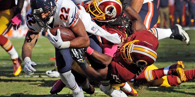 Chicago Bears running back Matt Forte (22) drags Washington Redskins strong safety Brandon Meriweather, center, and inside linebacker London Fletcher, right, into the end zone for a touchdown during the second half of a NFL football game in Landover, Md., Sunday, Oct. 20, 2013. (AP Photo/Nick Wass)