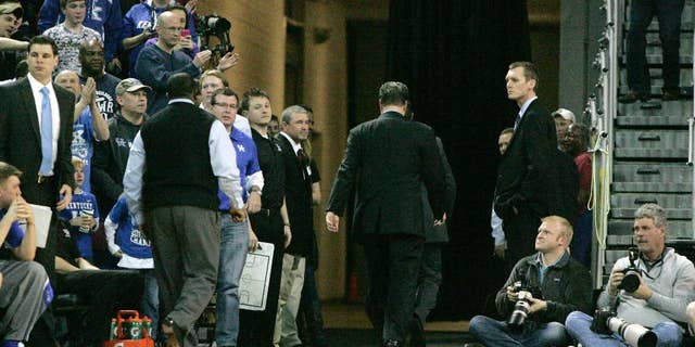Kentucky coach John Calipari leaves after being ejected during the second half of Kentucky's NCAA college basketball game against South Carolina on Saturday, March 1, 2014, in Columbia, S.C. (AP Photo/Mary Ann Chastain)
