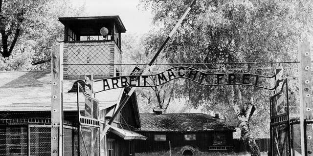 Auschwitz concentration camp gate with the inscription "Arbeit macht frei", after its liberation by Soviet troops, in a photo taken on April 1945