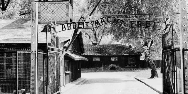 Auschwitz concentration camp gate with the inscription "Arbeit macht frei", after its liberation by Soviet troops, in a photo taken on April 1945