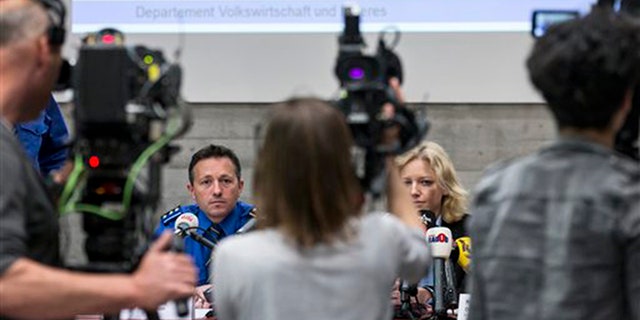 Police captain Markus Gisin, left, and prosecutor Barbara Loppacher, right inform the media in Schafisheim, Switzerland. about the killing of a family in Rupperswil in December. Officials in the nearby Swiss town of Rupperswil are expressing shock after the arrest of a 33-year-old soccer coach over the killing of four people. (AP)