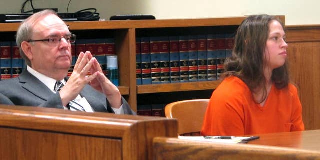 FILE - In this Aug. 20, 2015, file photo, Brittany Pilkington, right, and her attorney, Marc Triplett, listen as a judge sets a bond in Bellefontaine, Ohio. An Ohio judge has delayed the trial of Pilkington, a woman accused of suffocating her three young sons out of jealousy at the attention her husband gave them. The judge granted the extension on Wednesday, Jan. 11, 2017, and ordered all motions to be filed by March 17. (AP Photo/Andrew Welsh-Huggins, File)