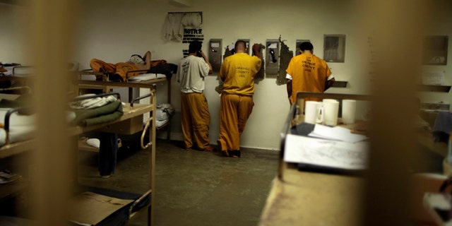 May 24, 2011: Inmates make phone calls from their cell at a county jail in Santa Ana, Calif.