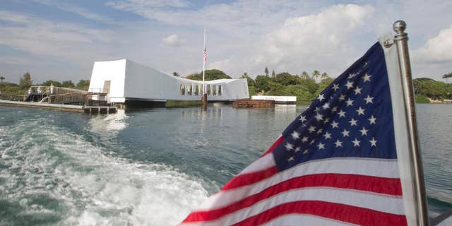 FILE - This Dec. 7, 2012 file photo shows The USS Arizona Memorial at Pearl Harbor, Hawaii. The Navy has investigated the case of a sailor who didn't salute as the national anthem played during a morning flag-raising at Pearl Harbor on Monday, Sept. 19, 2016. (AP Photo/Eugene Tanner, File)