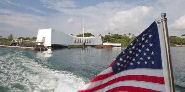 FILE - This Dec. 7, 2012 file photo shows The USS Arizona Memorial at Pearl Harbor, Hawaii. The Navy has investigated the case of a sailor who didn't salute as the national anthem played during a morning flag-raising at Pearl Harbor on Monday, Sept. 19, 2016. (AP Photo/Eugene Tanner, File)