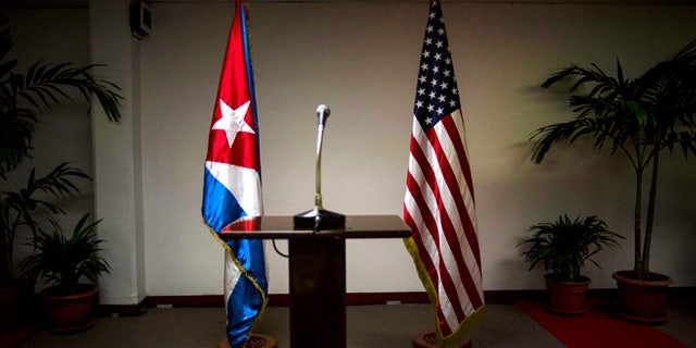 FILE - In this Jan. 22, 2015 file photo, a Cuban and U.S. flag stand before the start of a press conference on the sidelines of talks between the two nations in Havana, Cuba. The U.S. hopes to open an embassy in Havana before presidents Barack Obama and Raul Castro meet at a regional summit in April, which will be the scene of the presidentsâ first face-to-face meeting since they announced on Dec. 17 that they will re-establish diplomatic relations after a half-century of hostility. (AP Photo/Ramon Espinosa, File)