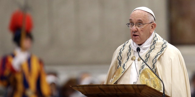 Pope Francis speaks in St. Peter's Basilica at the Vatican, Saturday, April 11, 2015. Pope Francis has proclaimed a special year of efforts by the Catholic Church to be more merciful and less judgmental. At St. Peter's Basilica Saturday evening, he listened as a Vatican prelate read excerpts from a papal bull, or decree, in which Francis proclaimed an "Extraordinary Jubilee of Mercy" Holy Year. The year begins on Dec. 8 with Francis' opening the normally closed Holy Door in the back of the basilica, and ends on Nov. 20, 2016. (AP Photo/Gregorio Borgia)