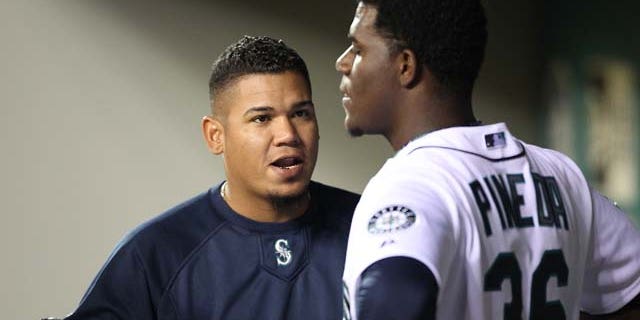 SEATTLE - APRIL 12: Felix Hernandez #34 of the Seattle Mariners talks with starting pitcher Michael Pineda #36 after he was removed from the game in the eighth inning against the Toronto Blue Jays at Safeco Field on April 12, 2011 in Seattle, Washington. The Mariners defeated the Blue Jays 3-2, and Pineda was credited with the win. (Photo by Otto Greule Jr/Getty Images)
