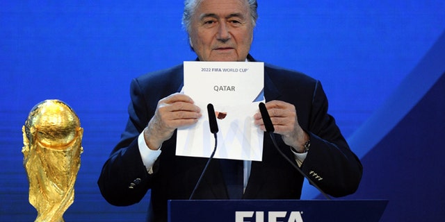 FILE - A Thursday, Dec. 2, 2010 photo from files showing FIFA President Joseph S. Blatter announcing that Qatar will be hosting the 2022 Soccer World Cup, during the FIFA 2018 and 2022 World Cup Bid Announcement in Zurich, Switzerland. Five officials, including three long-serving FIFA executive committee members, are being investigated in the corruption probe into the bidding contests for the 2018 and 2022 World Cups. A person familiar with the cases confirmed the names Thursday, Nov. 27, 2014, to The Associated Press after the five were identified in European media reports. The person spoke on condition of anonymity because the FIFA probe is confidential. FIFA President Sepp Blatter has backed the view that evidence in a 430-page report submitted by an investigations team cannot be disclosed. (AP Photo/Keystone/Walter Bieri, File)