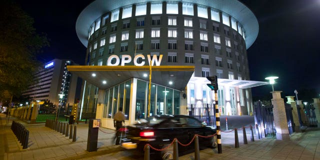FILE - In this Friday Sept. 27, 2013 file photo a car arrives at the headquarters of the Organization for the Prohibition of Chemical Weapons, OPCW, in The Hague, Netherlands. The OPCW were awarded the Nobel Peace Prize on Friday, Oct. 11, 2013. (AP Photo/Peter Dejong, File)